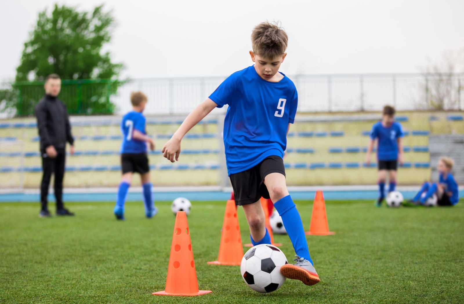 A young child plays soccer unimpeded by eyeglasses or traditional contact lenses.