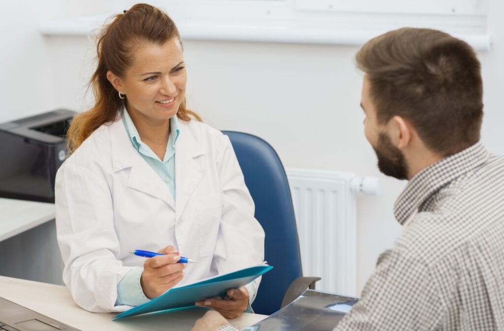 An optometrist talks with their patient during a dry eye treatment consultation to determine if IPL is the right treatment.