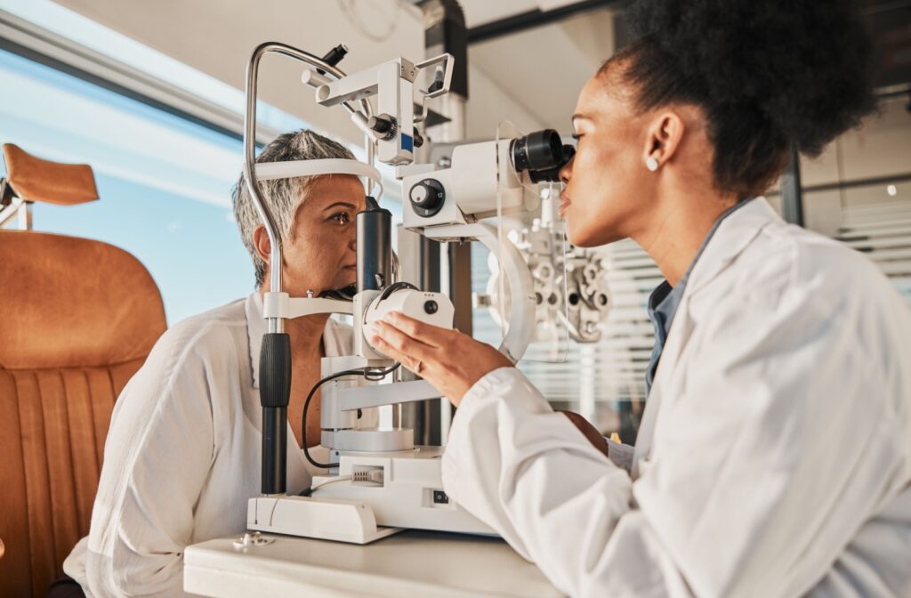 An eye doctor conducts a patient's slit lamp exam during a routine visit.