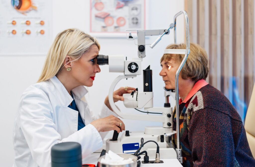 An optometrist evaluating a patient's health with a slit lamp during a routine eye exam.