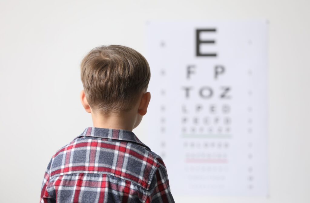 A child looking at letters on the wall during an eye exam