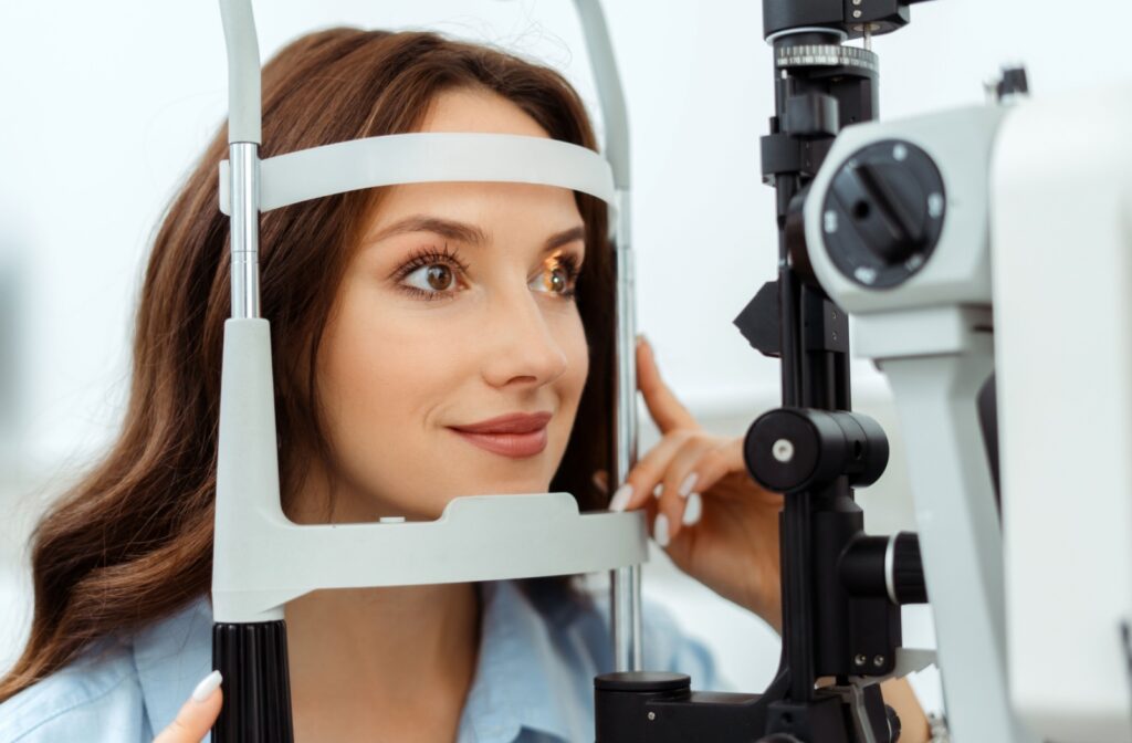 a patient getting her eye examined using the slit lamp device