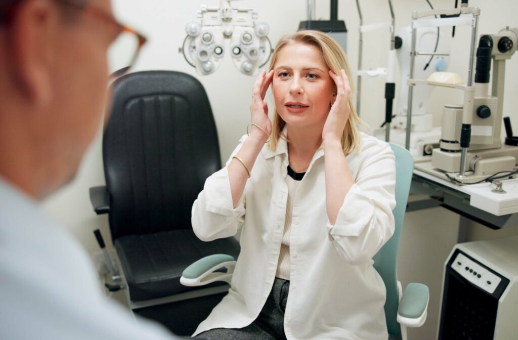 A person points to their temples while talking to an optometrist about their dry eye