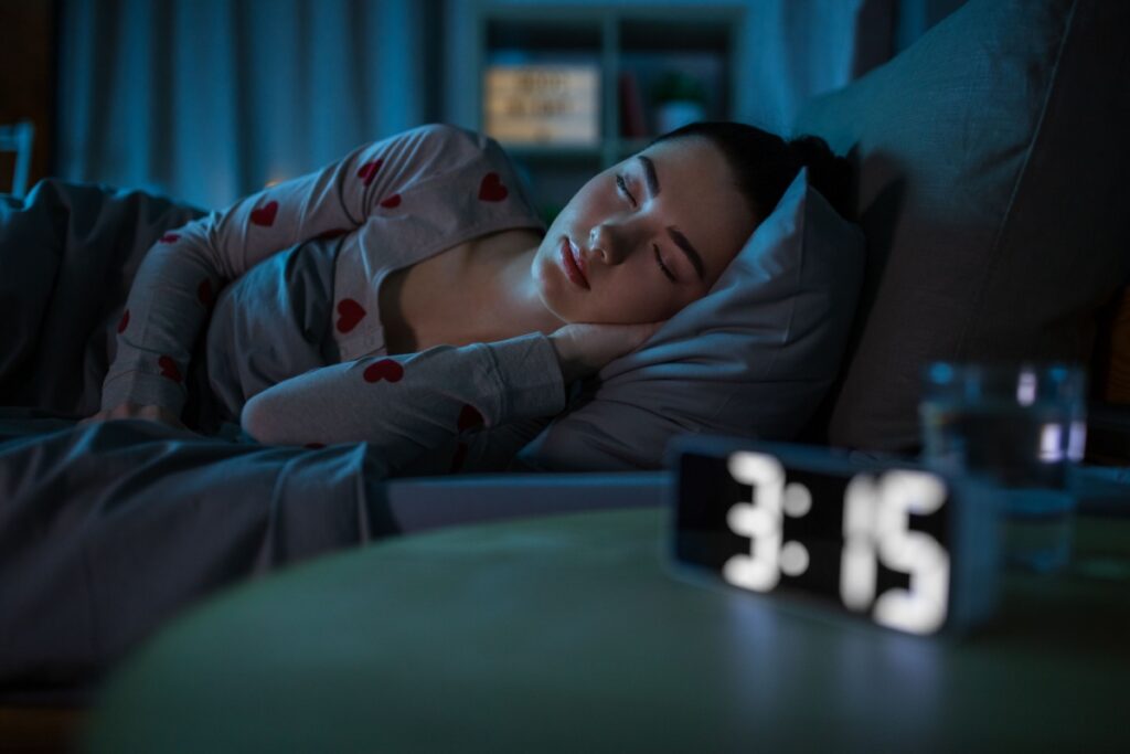 A person sleeping in bed at night with ortho-k lenses in